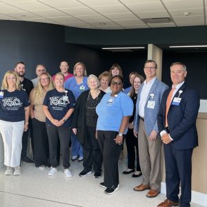 HSHS St. Elizabeth’s Hospital leadership and registration colleagues gathered in the newly designed Outpatient Registration space for a blessing and walk through on July 9, 2026, a day before opening to patients on July 10. The new registration space is the first area completed in the campus’ $116 million transformation project. The department’s location is just inside the outpatient entrance allowing quick access for patients checking in for their appointments and walk-in testing.